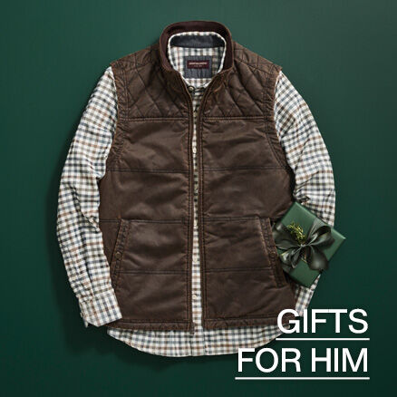 Flatlay of a men's vest and plaid long sleeve shirt with holiday present by it's side. 